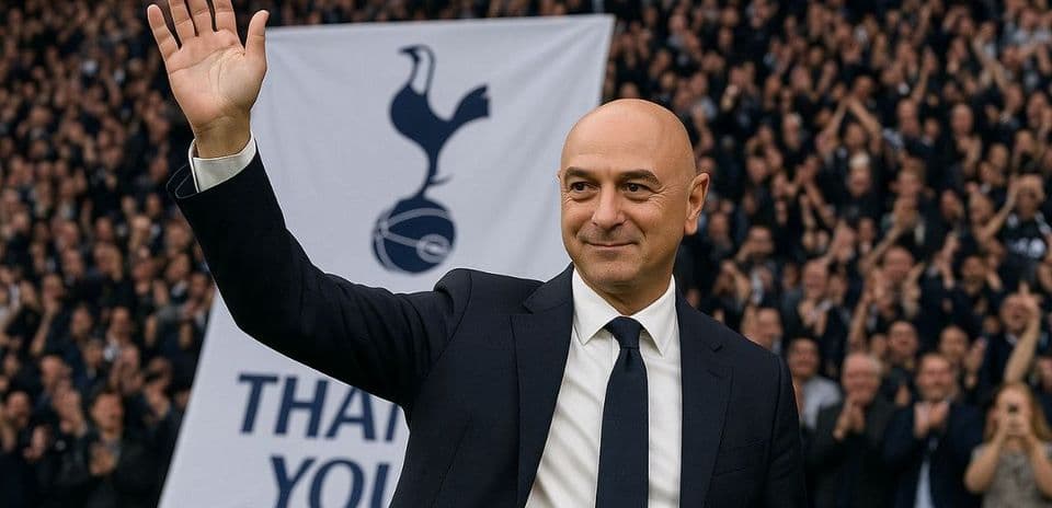 Man waving to crowd with Tottenham banner behind