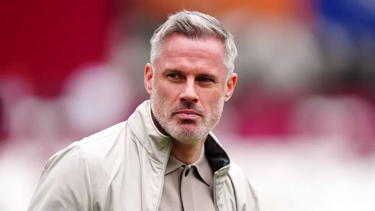 Man in light jacket looking intently at camera