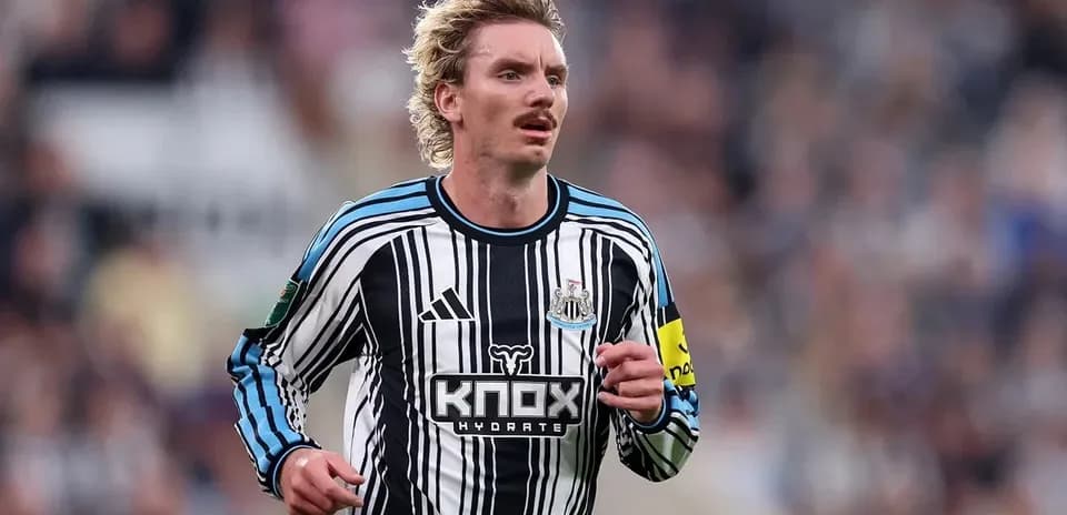 Player running in Newcastle United jersey during match