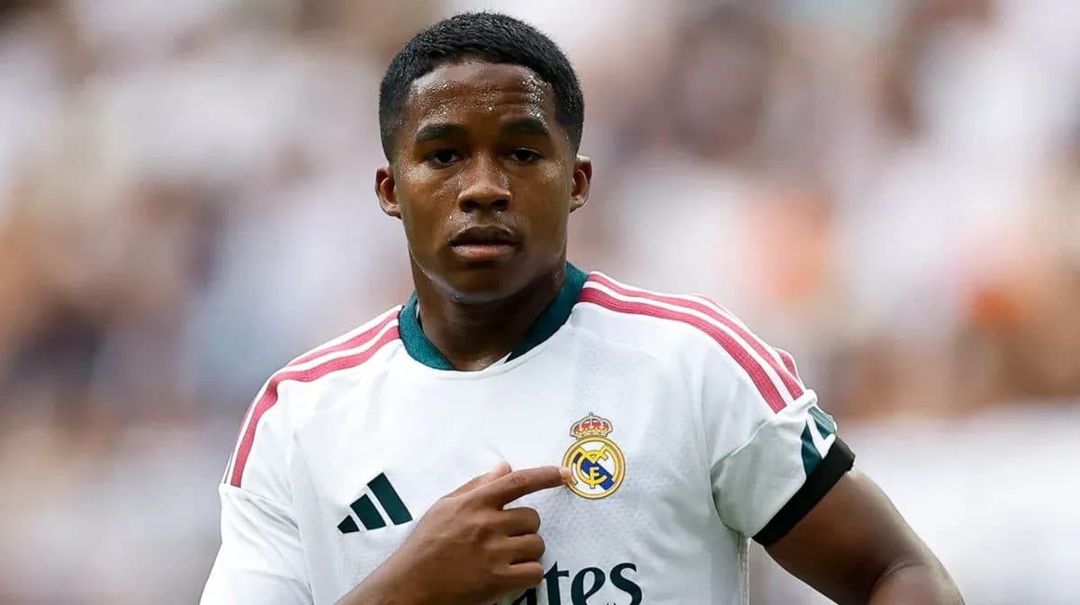 Player pointing to Real Madrid logo on jersey