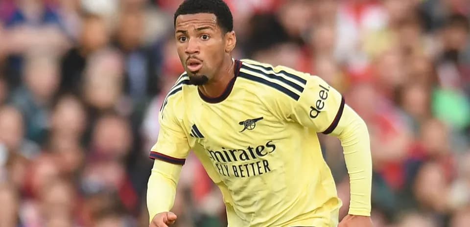 Player in yellow Arsenal kit running during match