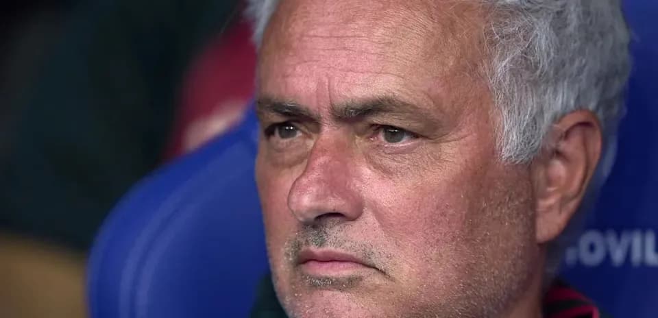Coach seated on the bench during match