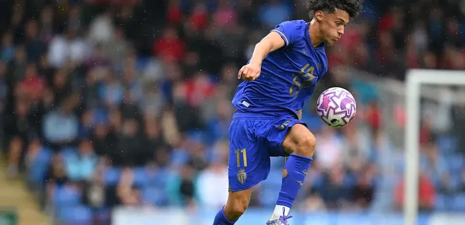 Player dribbling ball during match in rain