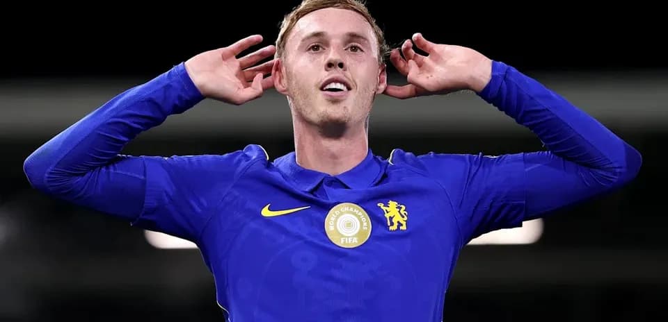 Player celebrating with hands on ears in blue kit