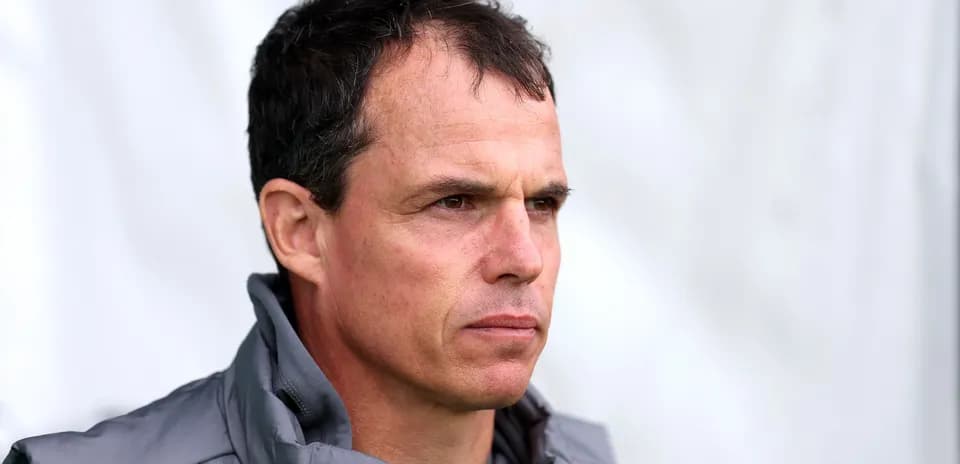 Coach observing training session with focused expression