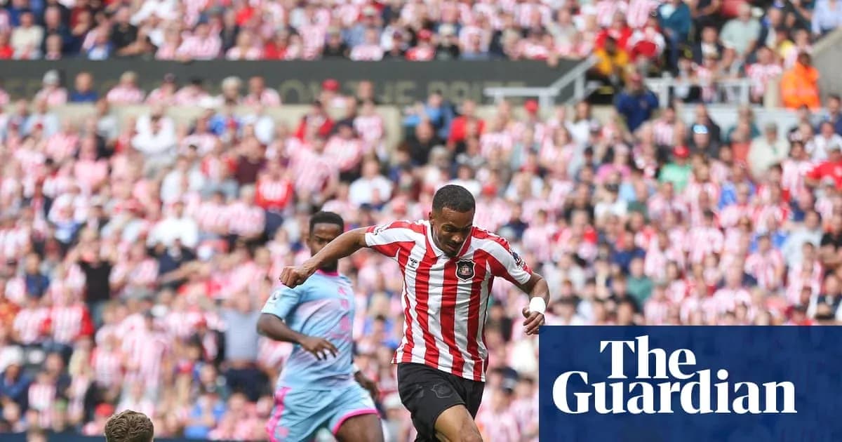 Player in red and white kit dribbling past opponent