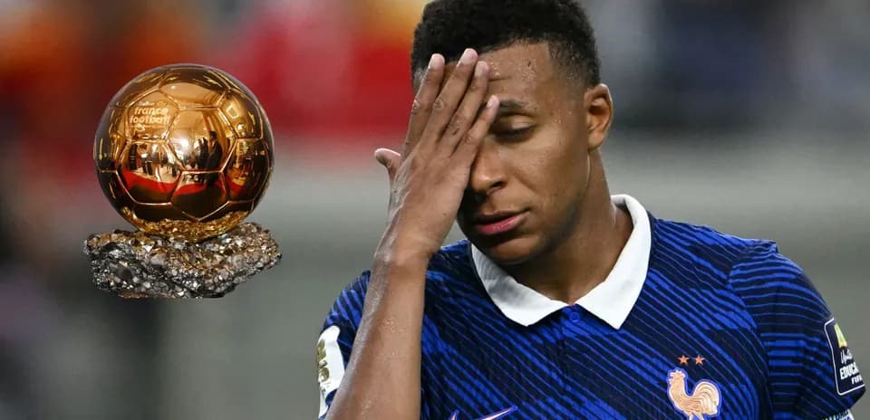 Player in France kit with Ballon d'Or trophy