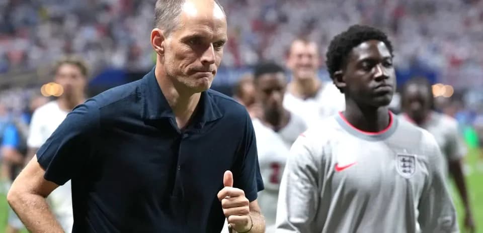 Manager walking off field with players after match