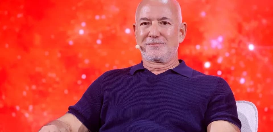 Person speaking at an event with red background