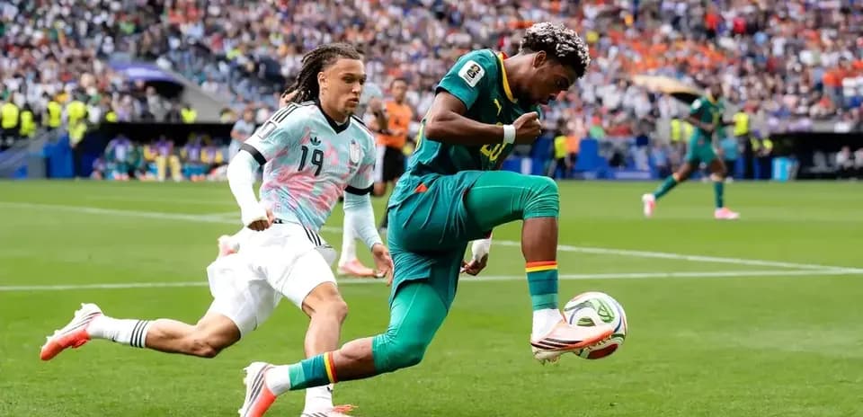 Player dribbling past opponent during football match