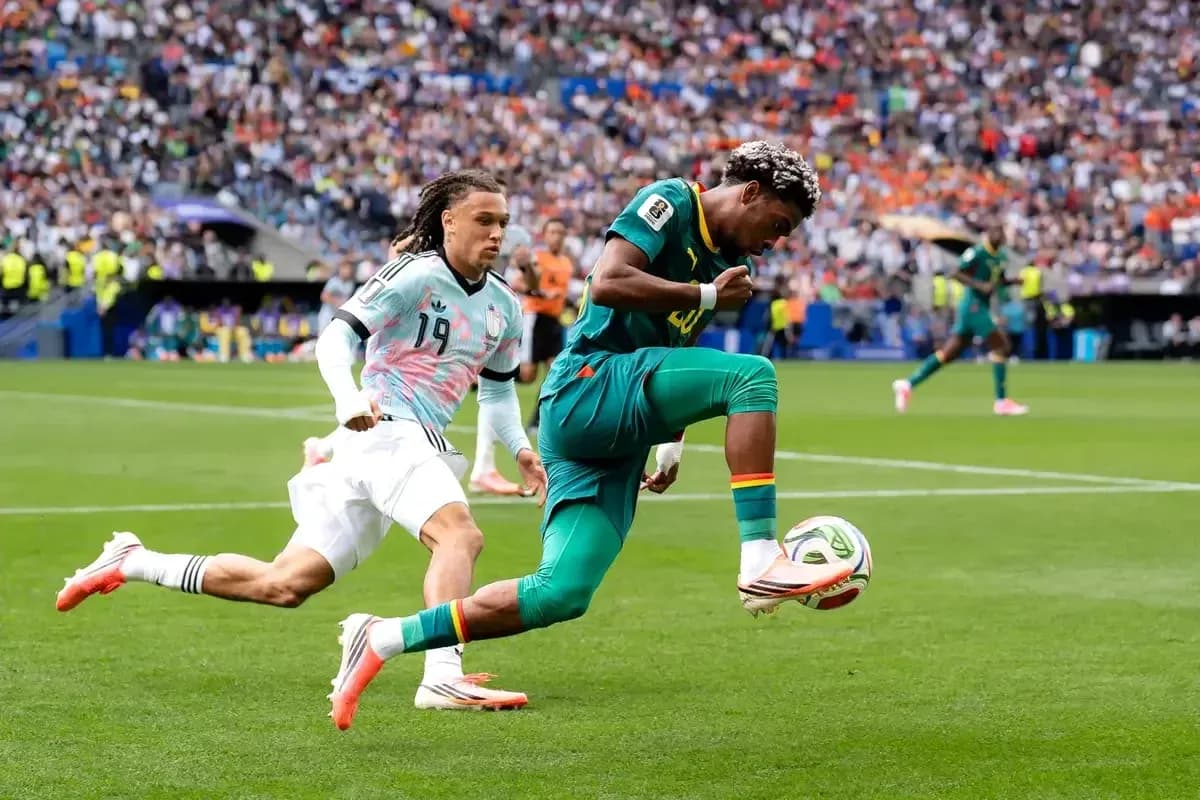 Player dribbling past opponent during football match