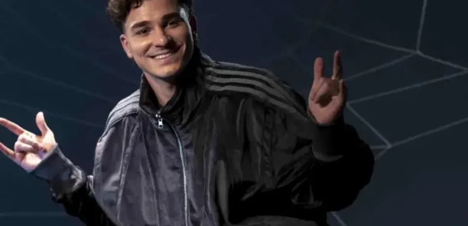 Person posing with hands in a dark background