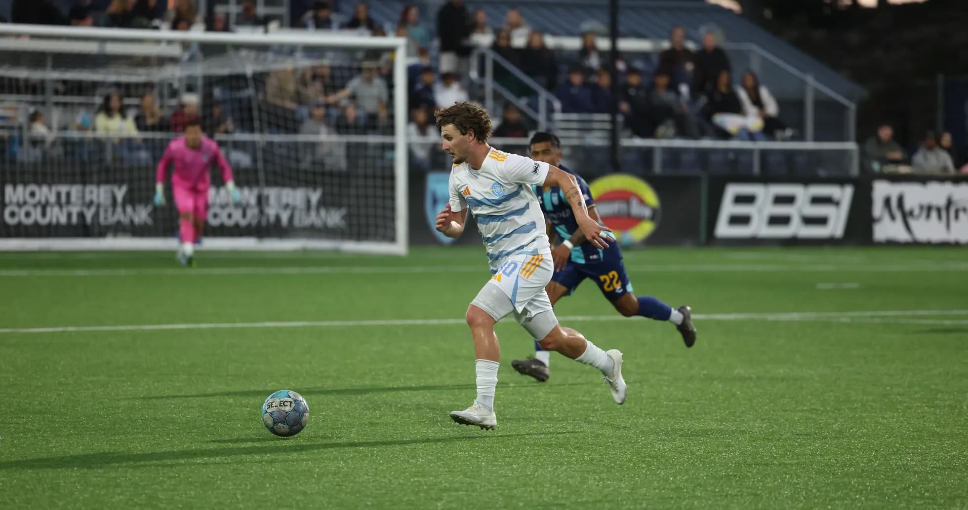Player from Monterey Bay dribbling the ball