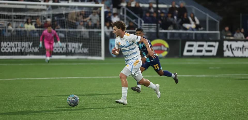 Player from Monterey Bay dribbling the ball