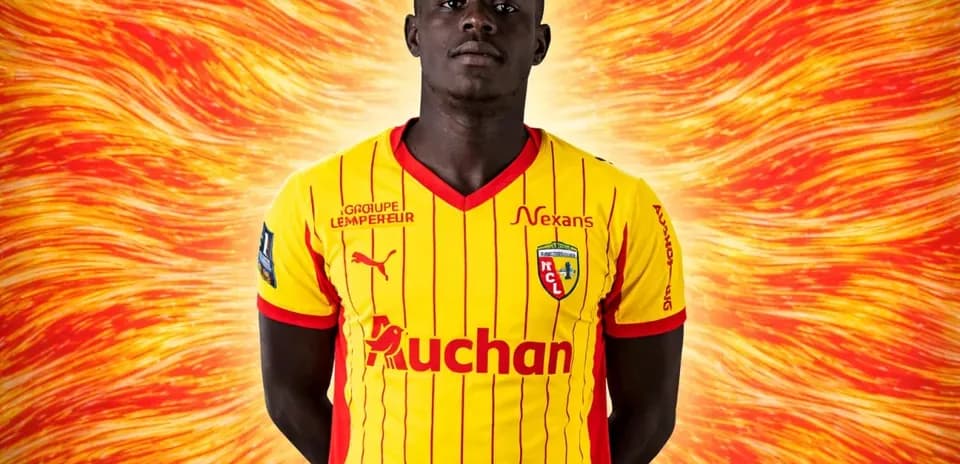 Player posing in yellow and red team jersey