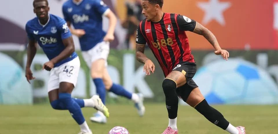Bournemouth player dribbling past Everton defender on pitch