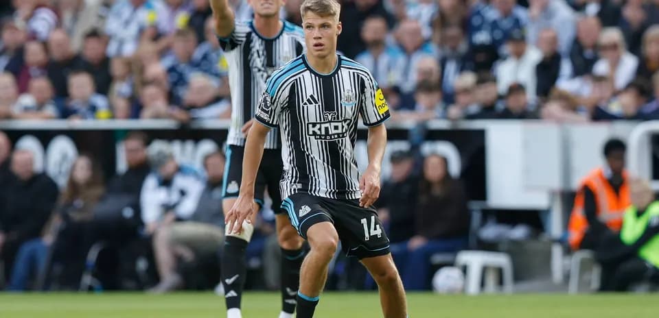 Newcastle player controlling the ball during match