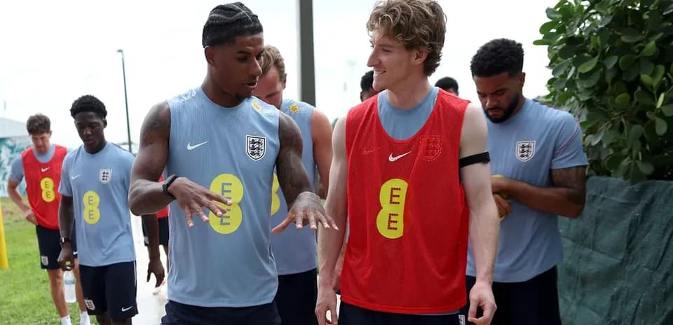 Players interacting during training session in England kits