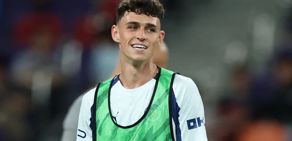 Player smiling while wearing training bib on pitch
