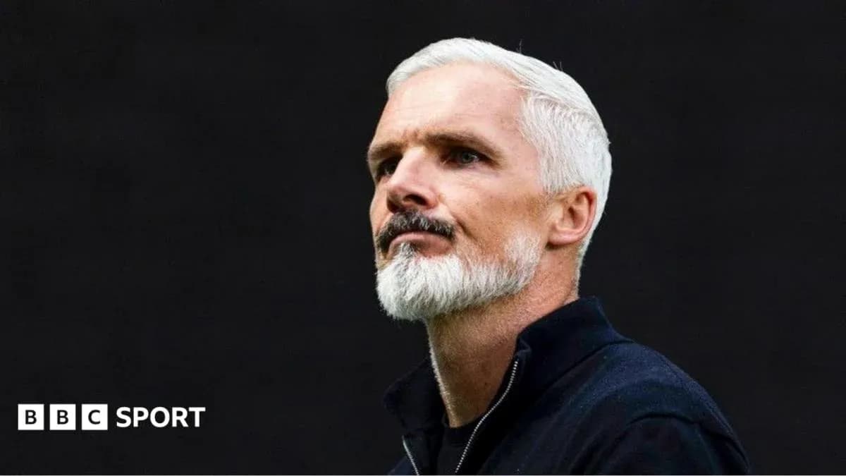 Coach with gray hair and beard looking thoughtfully