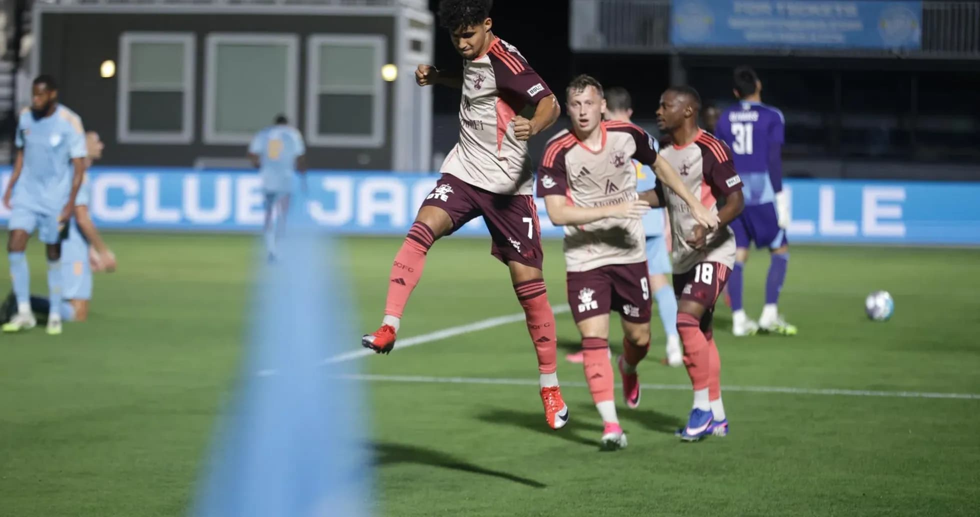 Players celebrating during JAX vs Detroit City match