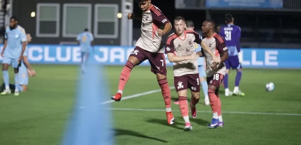 Players celebrating during JAX vs Detroit City match