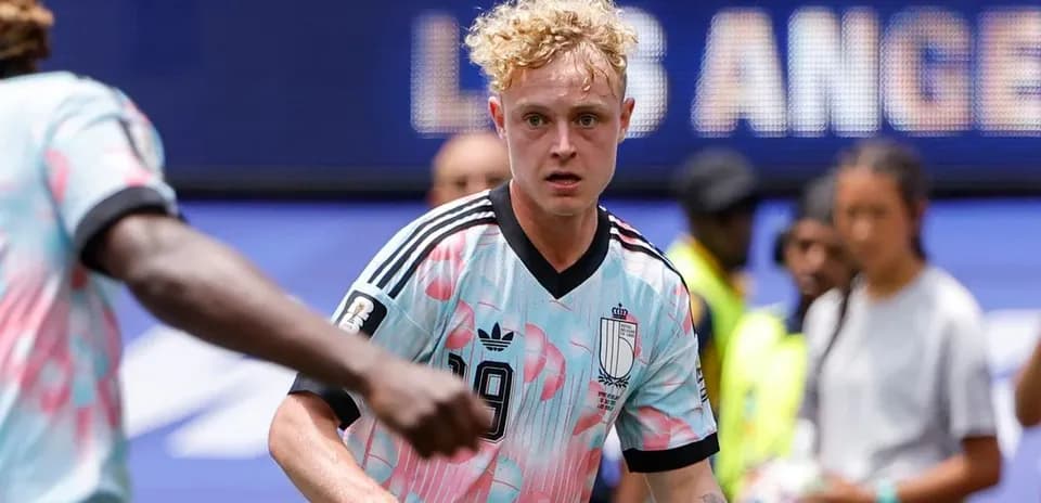 Player wearing pink and blue jersey on field