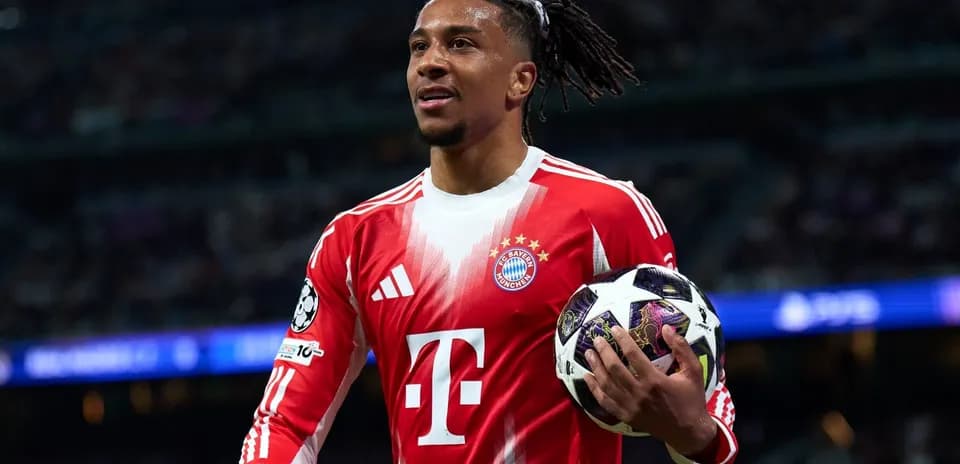 Player holding a Champions League ball on field