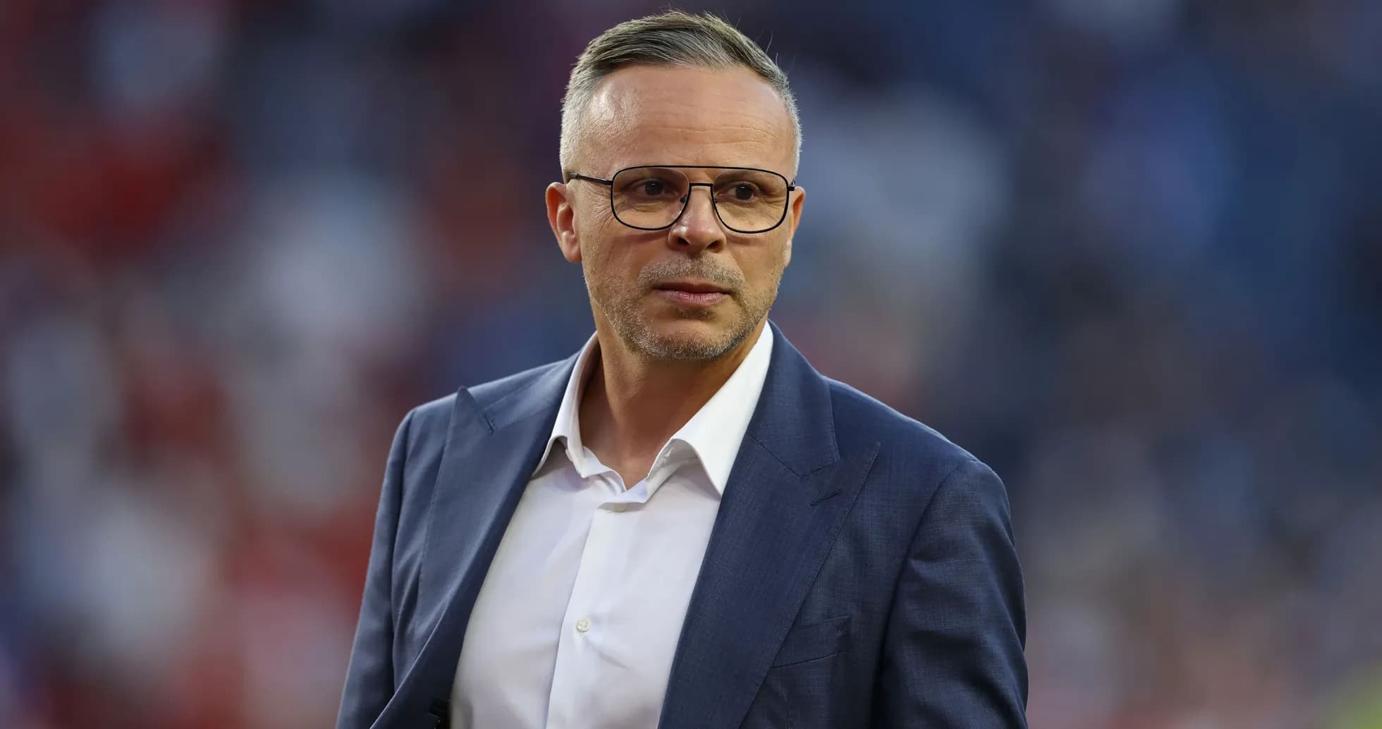 Man in suit with glasses on the field