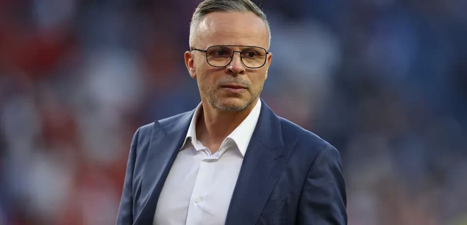 Man in suit with glasses on the field