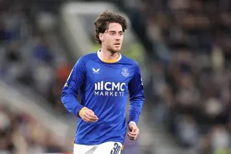 Player in blue kit running on the field