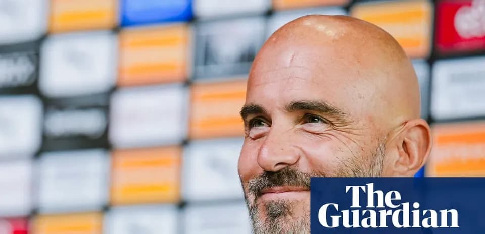 Manager smiling at press conference backdrop