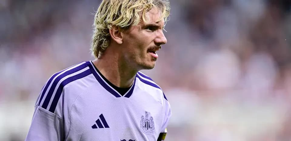 Player in purple Newcastle jersey on the field