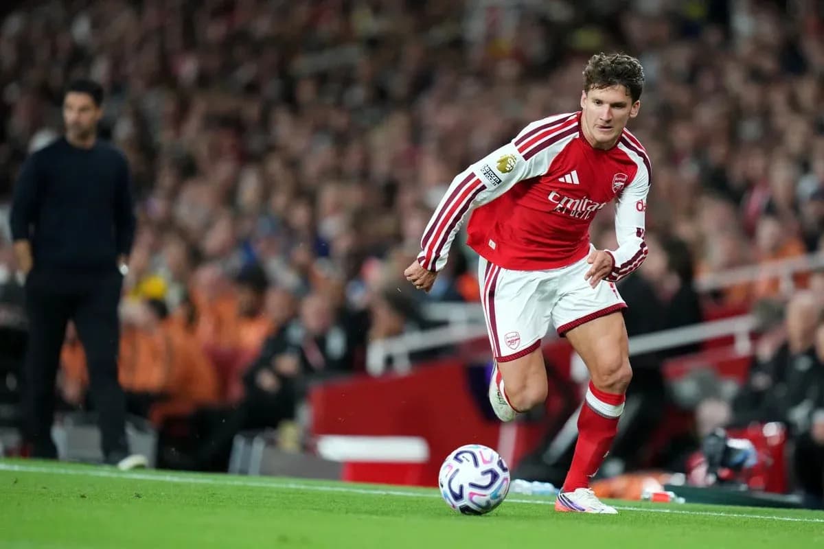 Player in red kit preparing to kick the ball