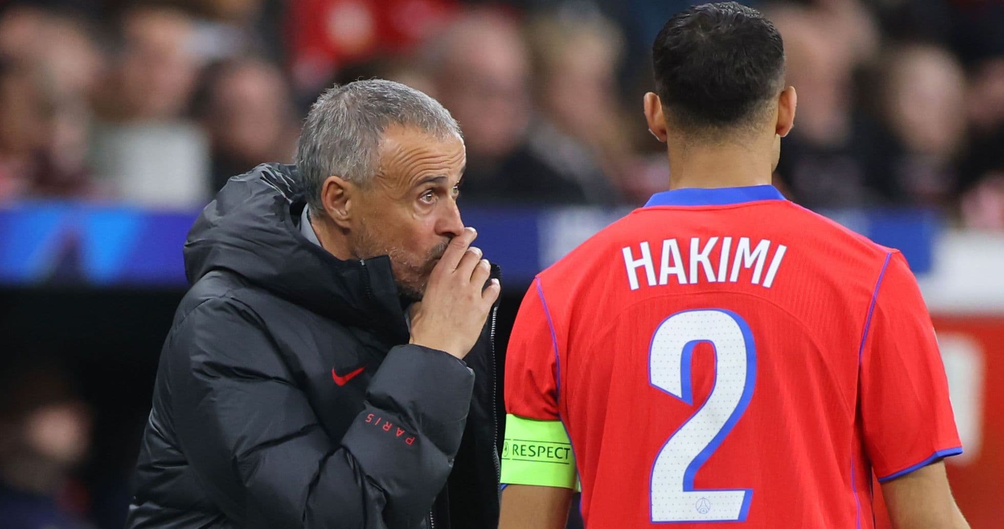 Coach giving instructions to player Hakimi on pitch
