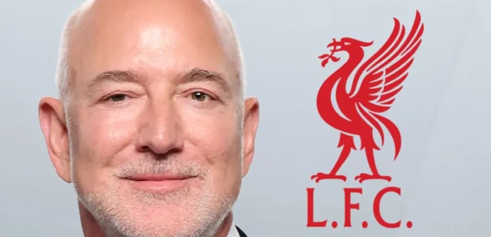 Man in tuxedo with Liverpool FC logo background