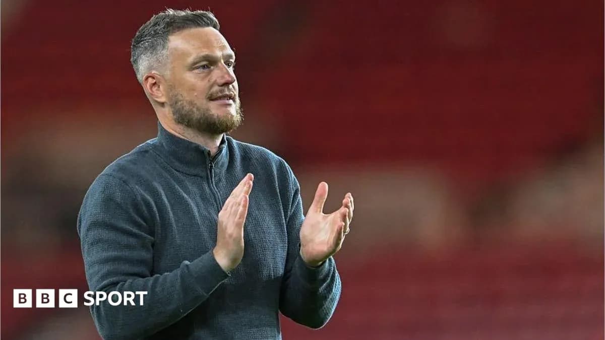 Coach applauding during post-match presentation