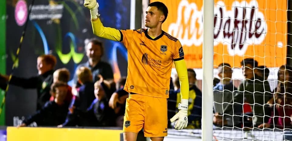 Goalkeeper signaling to fans during a match