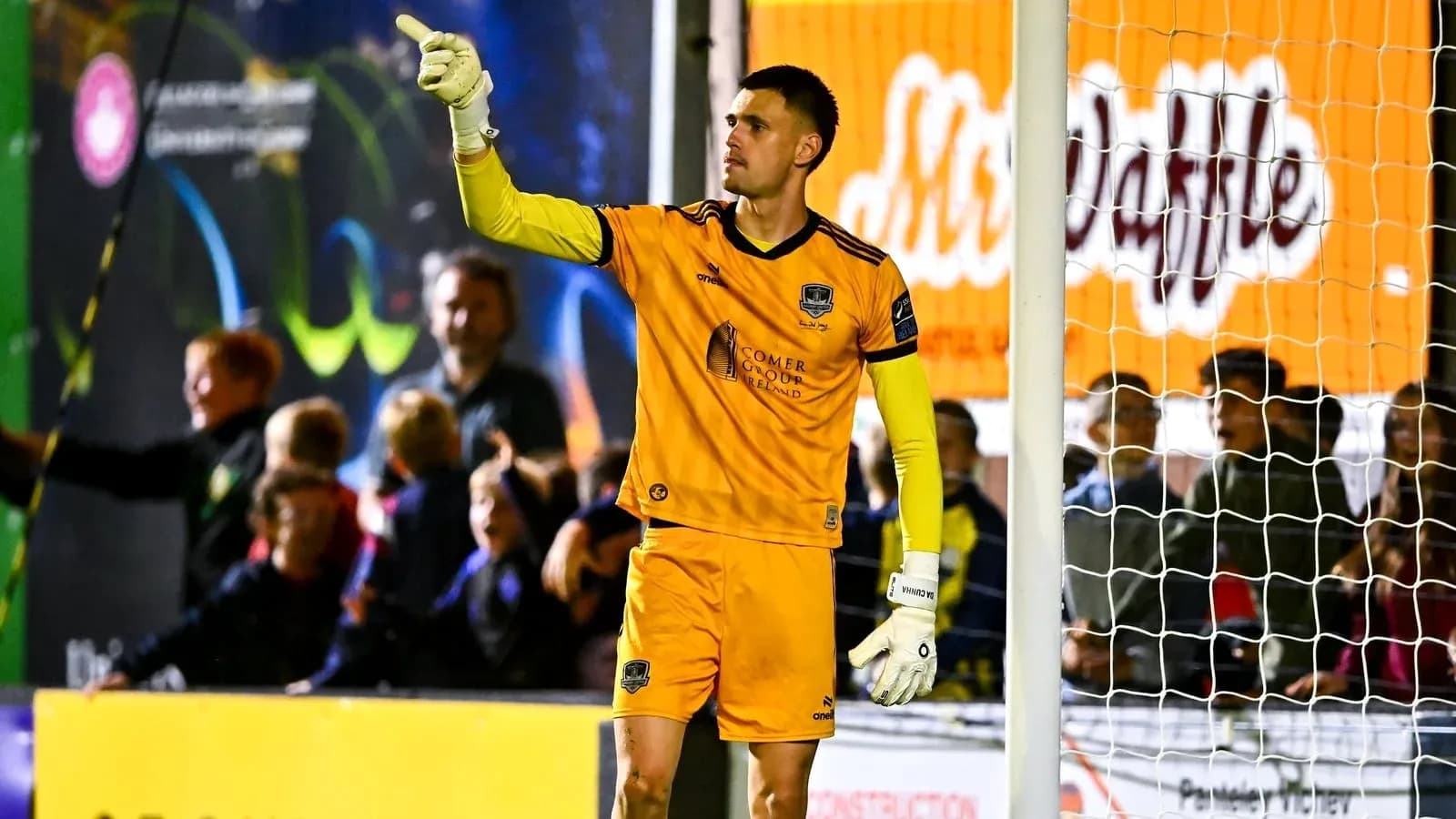 Goalkeeper signaling to fans during a match