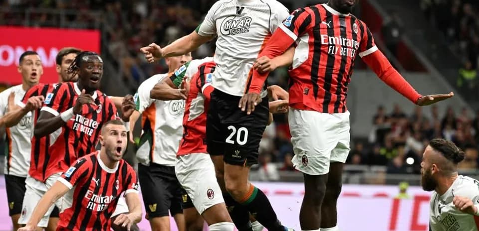 Players contesting for the ball in AC Milan match