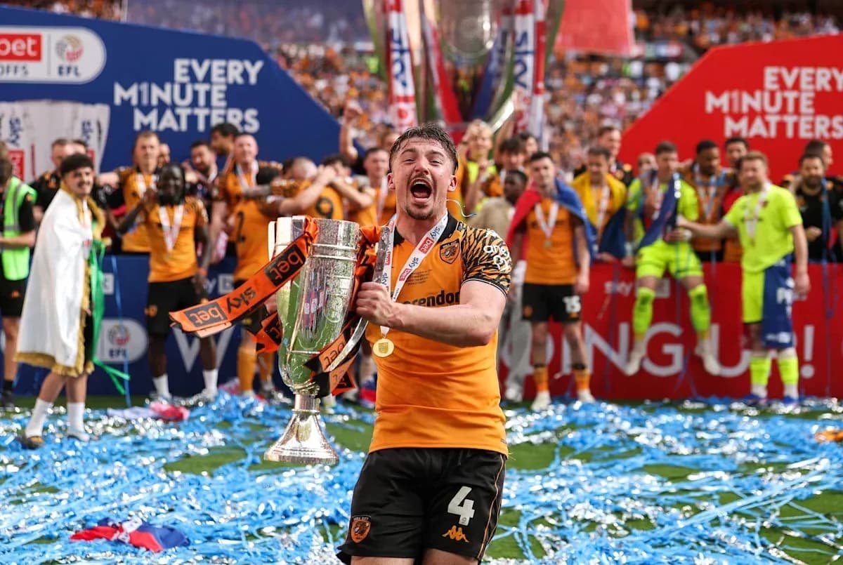 Player celebrating with trophy on victory podium