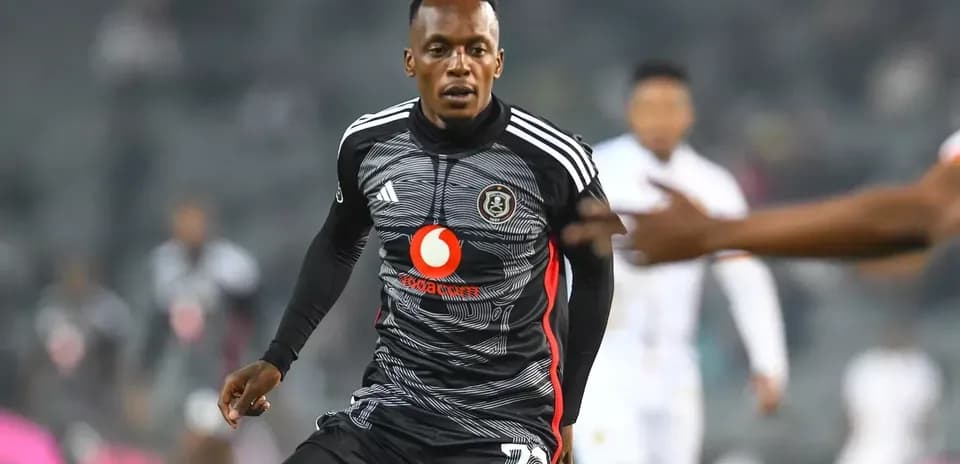 Player in black kit running on the field