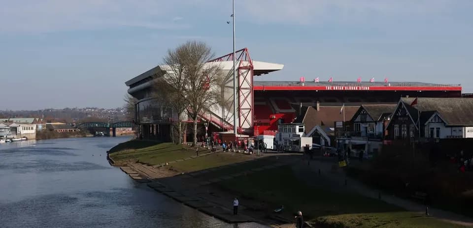 Cityscape featuring stadium by a riverbank