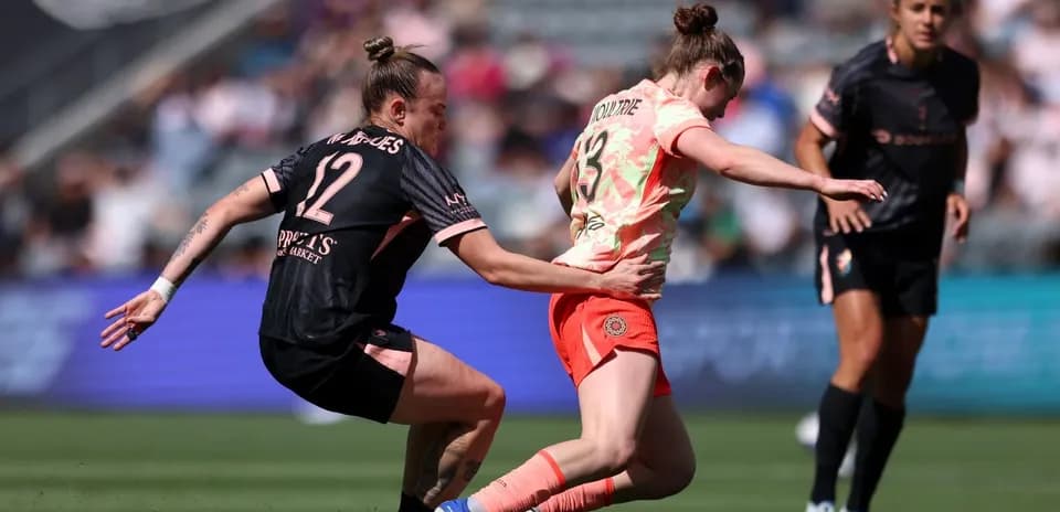 Portland Thorns W player challenged by Utah Royals W opponent