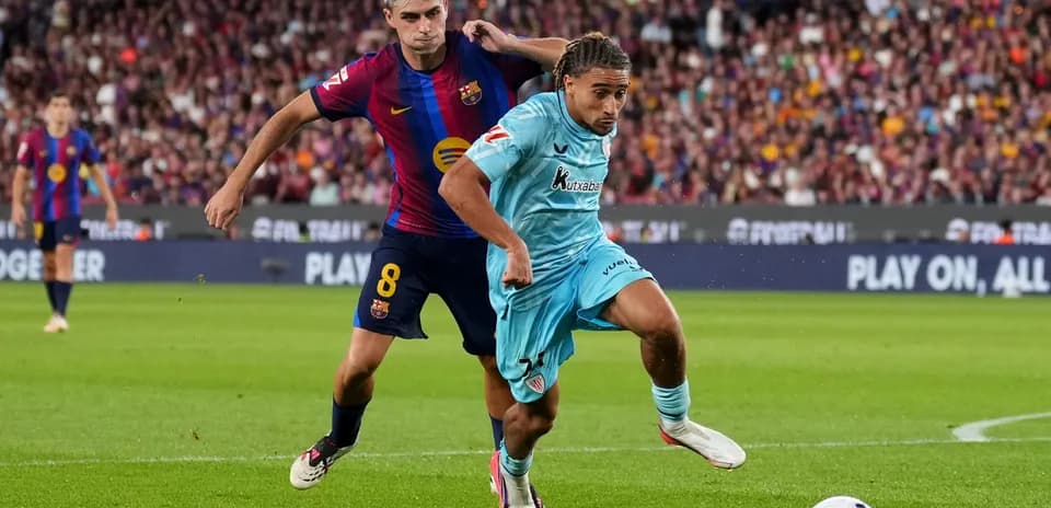 Player from Barcelona tackling opponent during match