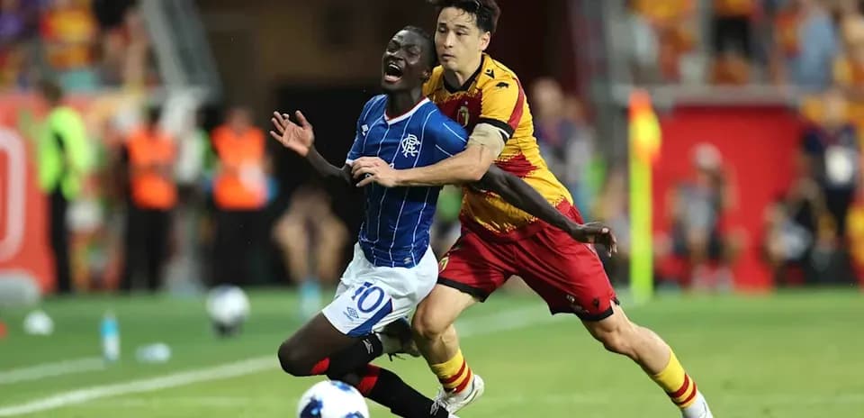 Player tackling opponent during Jagiellonia vs Rangers match