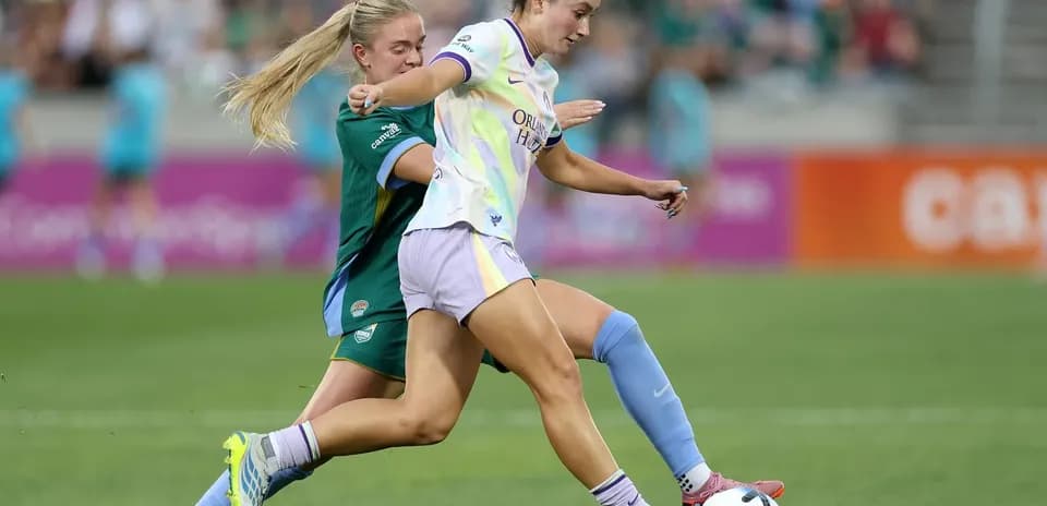 Orlando Pride player dribbling past Bay FC defender