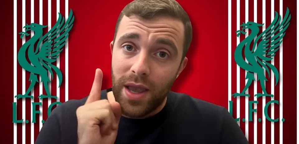 Person speaking with Liverpool FC logo in background