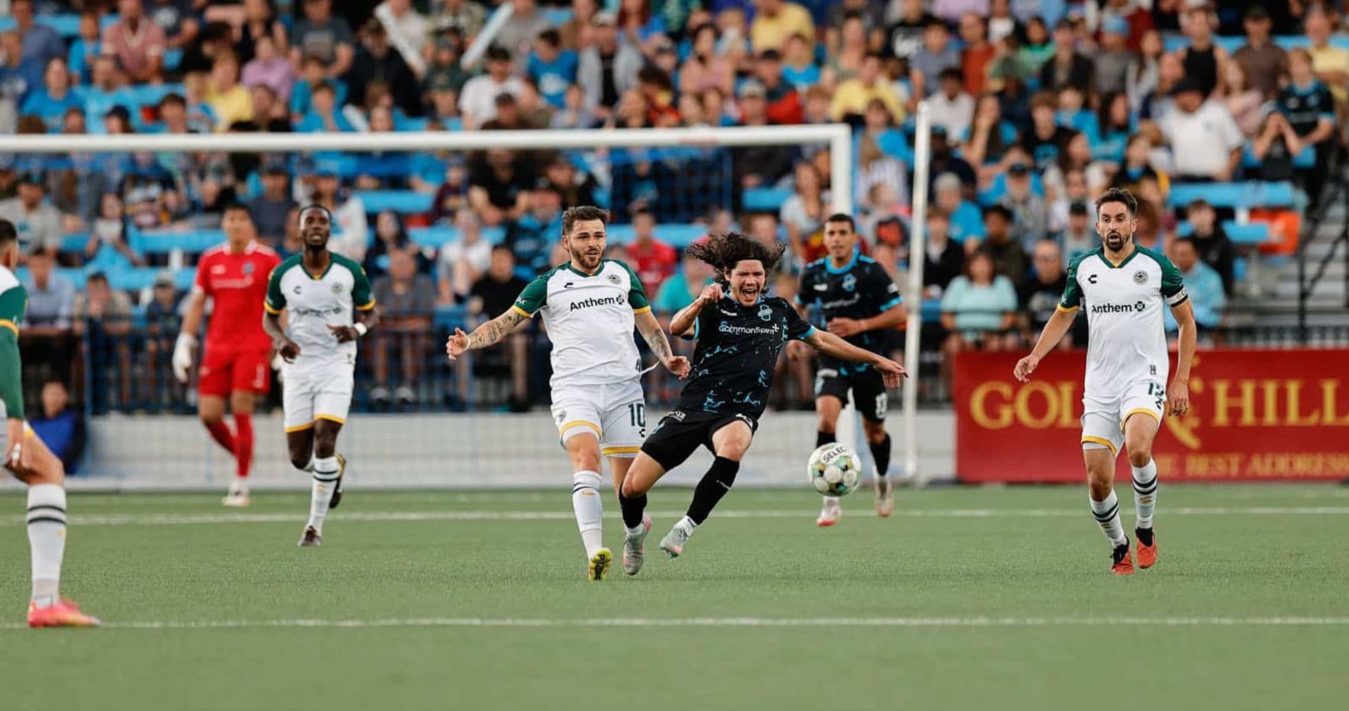 Players competing for the ball during match