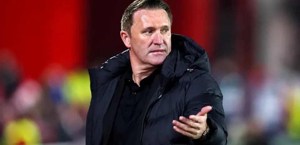 Coach gesturing during a football match on sidelines